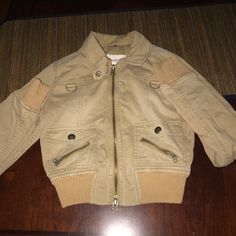 Like New! Worn Once. Abercrombie & Fitch Tan Moto Jacket. In Perfect Condition. Well Made Fall Jacket Can Be Worn Zipped Or Unzipped. Cute Floral Lining With Ribbed Wrists And Bottom Of Jacket. Full Functional Zipper Closure As Well As Pockets With Buttons On Front And Zippers On Pockets. Says Abercrombie And Fitch On Buttons Size S From Top Of Arm 28” From Shoulder Seam 24” From Top Of Jacket To Bottom 20” Width Measured On Back 16” Casual Winter Biker Jacket With Zip Cuffs, Khaki Zip Fly Outerwear For Fall, Beige Fall Outerwear With Zip Cuffs, Collared Biker Jacket With Zipper For Winter, Winter Biker Jacket With Zipper And Collar, Collared Spring Outerwear With Zipper Closure, Collared Outerwear With Zipper For Spring, Collared Outerwear With Zipper Closure For Spring, Casual Biker Jacket With Zip Cuffs For Fall