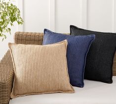 four pillows sitting on top of a white couch