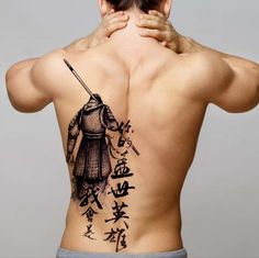 the back of a man with tattoos on his body