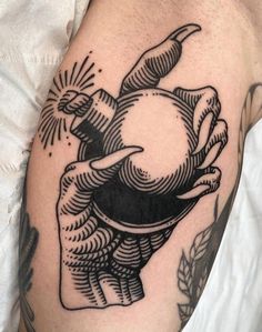 a black and white tattoo on the arm of a person