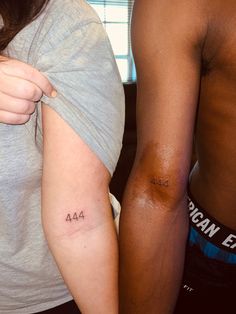 two people with small tattoos on their arms