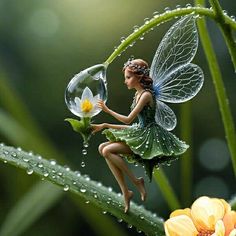 a fairy figurine sitting on top of a flower