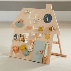 a wooden toy house with various items on it