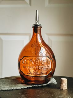 an old glass bottle sitting on top of a table