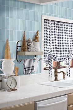 a kitchen with blue and white tiles on the backsplash, counter tops, and cabinets