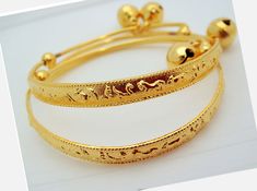 Handmade item from Thailand Materials: Brass, Gold Real 18k & 24K gold plated/Nickel free This is a set of two brand new 23K Thai gold new born anklet bracelet. They measure diameter 4.5-5.5 CM Circumference: 17 CM Adjustable Weight about: 13 grams The anklet can be enlarged so the feet of a baby can insert easily. The round ball is ringing FREE JEWELRY BAG WITH EVERY ITEM Description All gold plated jewelry was sent directly to us from the manufacturer in Bangkok This Unique Jewelry Is Bras Adjustable Gold Bracelet For Ceremonial Occasions, Traditional Gold Anklets With Adjustable Fit, Traditional Gold Adjustable Anklets, Traditional Gold Anklets Adjustable, Adjustable Gold Bracelet For Festive Occasions, Bell Anklet, Jewelry Bag, Baby Set, Anklet Bracelet