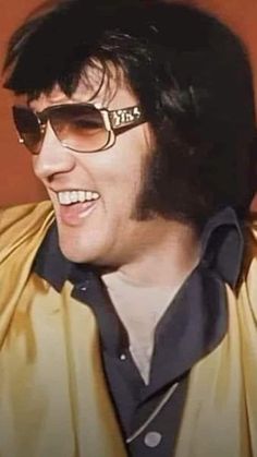 a man wearing sunglasses and smiling for the camera