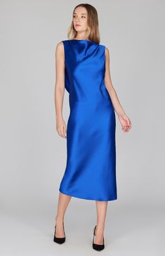 Our signature bias cut silhouette, updated with a gracefully draped front and low back detail. Cut in a flattering midi length with a clean baby hem finish. This dress is unlined and needs no closures thanks to the nature of bias cut fabric. Spring Evening Midi Dress With Cowl Back, Silk Midi Dress With Side Slits For Cocktail, Formal Blue Midi-length Asymmetrical Dress, Chic Blue Bias Cut Maxi Dress, Formal Draped Midi Dress With Side Slits, Elegant Blue Midi Dress With Bias Cut, Silk Midi Dress With Side Slits, Chic Draped Midi Dress With Side Slits, Spring Blue Bias Cut Midi Dress