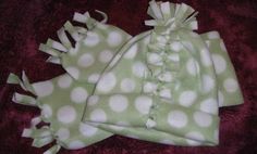 two green and white polka dot baby hats