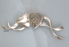 "Vintage designer JJ sterling silver 925 two Hearts pin/brooch. It is in very good condition, new old stock. It measures 2 5/8 inches long and 7/8\" tall. The weight of it is 0.4 oz. It is quality marked JJ Sterling. We combine shipping, If you want to take advantage of the reduced shipping you must contact us before you pay for your items so we can send you a corrected invoice. Thank You for visiting our Etsy store https://www.etsy.com/shop/VictoryIssweet !" Elegant Silver Heart Brooch, Elegant Silver Heart-shaped Brooch, Elegant Silver Heart-shaped Brooches, Elegant Silver Heart Brooches, Silver Heart-shaped Brooch For Valentine's Day, Silver Heart Brooch For Valentine's Day, Valentine's Day Silver Heart Brooch, Vintage Silver Brooches For Valentine's Day, Silver Brooches For Anniversary On Valentine's Day