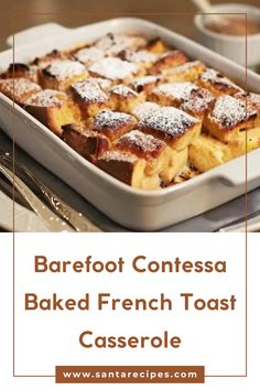 baked french toast casserole in a white dish with powdered sugar on top