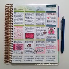 a planner with stickers on it next to a pen