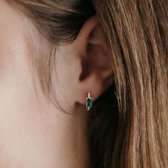 These bezel-set emerald and diamond earrings snuggle close to the lobe for an everyday subtle showstopper. Set in high polished 14K yellow gold. Wear with our matching necklace, bracelet, and ring. Natural Emeralds: 0.40ctw Natural Diamonds: 0.05ctw 14K Yellow Gold Length: 1/2 Inch Everyday Jewelry With Bezel Setting For May Birthstone, 14k Gold Bezel Set Huggie Earrings, Yellow Gold Huggie Earrings With Bezel Setting As Gift, Classic Huggie Birthstone Jewelry, Cubic Zirconia Gemstone Huggie Jewelry, Cubic Zirconia Gemstone Huggie Earrings, Yellow Gold Huggie Earrings Gift, Elegant Green Huggie Jewelry, Fine Jewelry Huggie Earrings With Bezel Setting For Gifts