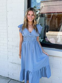 Think of a beautiful day with blue skies all wrapped up in a dress. This short sleeve, midi dress features a V-Neck, ruffled collar and covered buttons. The back ties above the waist, leaving the back partially exposed. This dress is fully lined. Shell: 100% polyester Lining: 97%polyester 3% spandex Model is wearing an extra small. Blue V-neck Short Sleeve Dress For Spring, Summer Midi Dress With Ruffles, Summer Midi Dress With V-neck And Smocked Back, Elegant Beach Midi Dress With Flutter Sleeves, Summer Maxi Dress With Flutter Sleeves For Day Out, Elegant Flutter Sleeve Midi Dress For Beach, Fitted Flutter Sleeve Midi Dress For Casual Occasions, Fitted Midi Dress With Flutter Sleeves For Casual Occasions, Fitted Midi Dress With Flutter Sleeves For Casual Wear