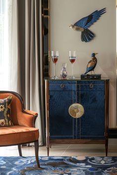 a living room with a blue cabinet and two birds on the top of it's shelf