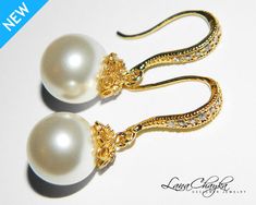 pair of earrings with pearls on white background