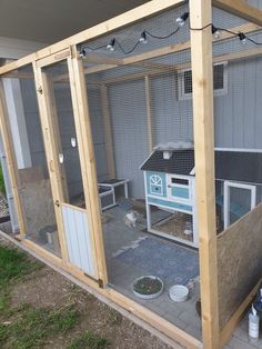 an outdoor chicken coop with two chickens inside