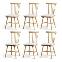 six wooden chairs with white cushions on the back and sides, all facing different directions