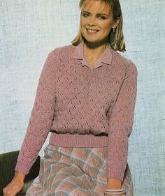 a woman wearing a pink sweater and plaid skirt sitting on a chair with her legs crossed