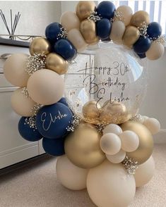 a birthday balloon arch with balloons and confetti on it in the shape of a wreath