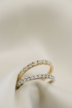 a diamond ring on top of a white cloth