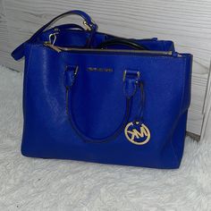 It’s In Like Brand New Condition Only One Minor Flaw In The Back Of The Purse As Seen On The Last Picture! Blue Bags With Branded Hardware, Blue Michael Kors Tote Shoulder Bag, Blue Michael Kors Shoulder Bag, Blue Michael Kors Bag For Shopping, Michael Kors Blue Bag For Shopping, Blue Michael Kors Shopping Bag, Classic Blue Bag With Zipper Closure, Blue Bags With Gold-tone Hardware For Errands, Michael Kors Blue Shoulder Bag With Removable Pouch