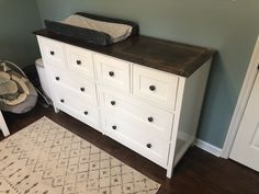 a baby crib and dresser in a room