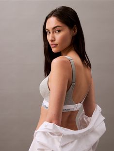 A Calvin Klein icon. This modern cotton bralette is the definition of effortless. Made with super soft and supple cotton stretch blended with modal for all day comfort. Designed with the original Calvin Klein logo band, this is a sporty look that feels sexy everyday with added lift and support.  Material: 53% Cotton, 35% Modal, 12% Elastane. Cotton Bralette, Sporty Look, Bralette, Calvin Klein, Band