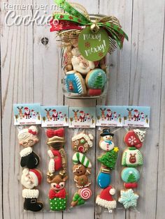 some christmas cookies in a jar on top of a wooden table