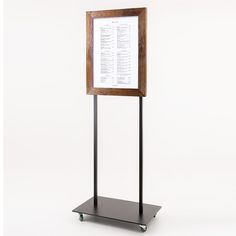 a wooden and metal stand with a sign on it's side that says,