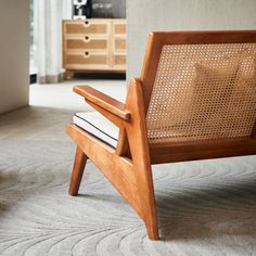 a wooden chair sitting on top of a carpeted floor