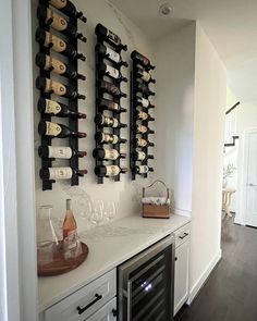 a wine rack with many bottles and glasses on it