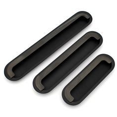 three pieces of black plastic sitting next to each other