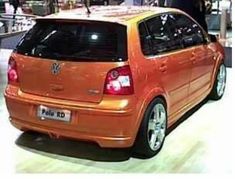 an orange vw golf car is on display