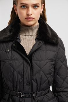 Designed for sophisticated women with a timeless style, the Cygne down jacket is easily layered over workwear and weekend leisure looks. Crafted from recycled polyester, the short puffer boasts geometric quilting and a nipped-in, belted silhouette. The lightweight style is finished with a detachable faux fur collar. Classic Long Sleeve Fur Coat With Padded Collar, Designer Quilted Winter Outerwear, Classic Black Outerwear With Faux Fur Trim, Luxury Long Sleeve Quilted Jacket For Winter, Designer Winter Quilted Jacket With Padded Collar, Designer Winter Outerwear With Faux Fur Lining, Luxury Puffer Jacket With Faux Fur Lining, Designer Quilted Jacket With Padded Collar For Winter, Designer Long Sleeve Outerwear With Faux Fur Trim