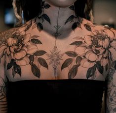 a woman with tattoos on her chest and neck