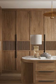 a room with wood paneling and a lamp on the table in front of it