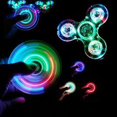 the person is playing with some colorful light - up fidgets in the dark