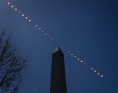 a long line of eclipses is seen in the sky over washington monument, as well as an obelisk