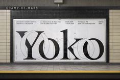 an advertisement on the side of a building for yoko, which has been painted black and white