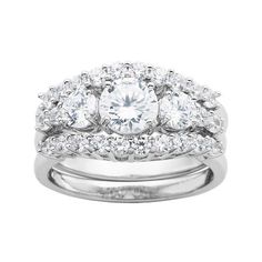 a white gold ring with three diamonds on the side and two rows of round brilliant cut stones