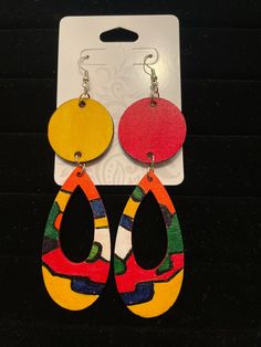 Hand Painted and designed by artist, Dee Dumas. Each earring is unique. Multi-colored teardrop earrings with red and yellow circle. Red, yellow, blue, green, orange, and white base. African Hand Painted Earrings, Multicolor Hand Painted Earrings, Multicolor Hand Painted Drop Earrings, Bold Handmade Multicolor Earrings, Multicolor Hand Painted Fun Earrings, Fun Multicolor Hand Painted Earrings, Artistic Multicolor Earrings With Colorful Design, Fun Multicolor Earrings With Colorful Design, Fun Multicolor Earrings