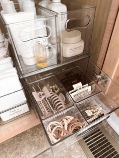 an organized drawer in the corner of a bathroom