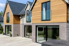 the house is made out of wood and has glass doors