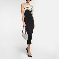 An Eye-Catching Design For Your Next Event, Staud's Nellie Midi Dress Is Made From A Heavyweight Knit And Shaped Into A Figure-Hugging Silhouette, With Opulent, Contrasting Ostrich Feathers To Adorn The Neckline. Material: 59% Viscose, 40% Nylon, 1% Elastane Trim: 100% Ostrich Feathers Care Instructions: Dry Clean Designer Colour Name: Black/ Ivory Hugging Silhouette, Ostrich Feathers, Color Names, Black And Tan, Feathers, Color Design, Care Instructions, Colorful Dresses, Dry Clean