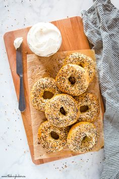 bagels on a cutting board with cream cheese