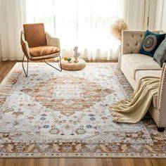 a living room with a couch, chair and rug in front of a large window