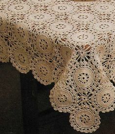 the table cloth has been crocheted with lace