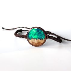 Celebrate the magnetic beauty above with a piece that reflects the stars and colors of a spectacular night sky. Inspired by nature, your new opal bracelet has been meticulously hand carved and designed out of precious burl wood, resin and lab grown opal.   Complete with tiny specs of silver dust, to mimic tiny stars.  Designed for women, its the perfect jewelry gift for your nature loving friends.  The opal changes color depending on light and comes in 5 color variations.  To bring out the beaut Adjustable Nature-inspired Jewelry Bracelet, Adjustable Nature-inspired Bracelet Jewelry, Nature-inspired Adjustable Bracelet Jewelry, Unique Resizable Bracelets For Gift, Adjustable Nature-inspired Bracelet, Nature-inspired Bracelet Jewelry As A Gift, Nature-inspired Adjustable Round Jewelry, Wearable Art Bangle Bracelet Gift, Wearable Art Bangle Bracelet For Gift