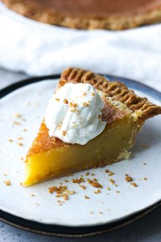 a piece of pie with whipped cream on top and the words cheese pie above it